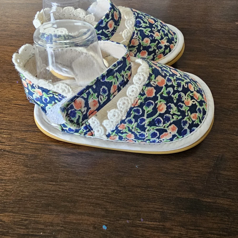 3 pairs of baby/girl shoes—soft, floral, and glittery—in various styles.